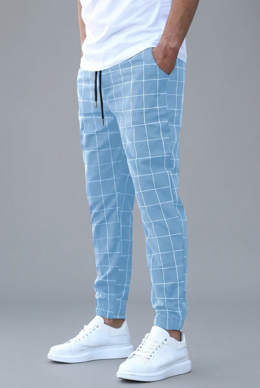 Light blue checkered pants worn by a person on a gray background